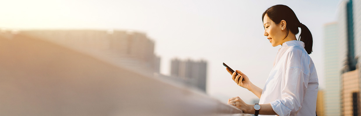 A woman is using her laptop outside; image used for HSBC Singapore eStatements