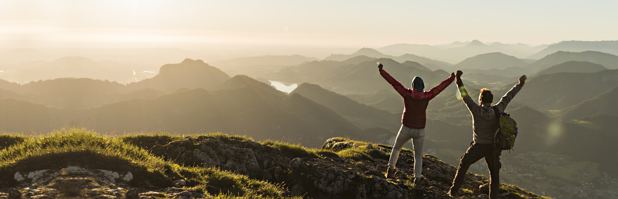 Couple reaching mountain summit; image used for HSBC 8 steps to prepare you for a great retirement article page.