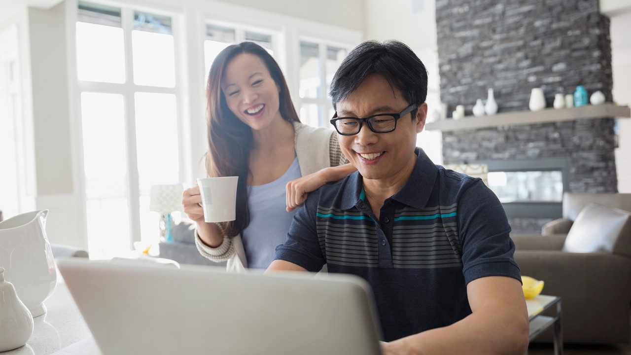  Couple using a laptop, image used for HSBC Mortgage to get a home equity loan