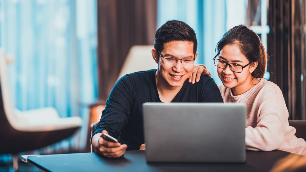 Couple using the laptop together.