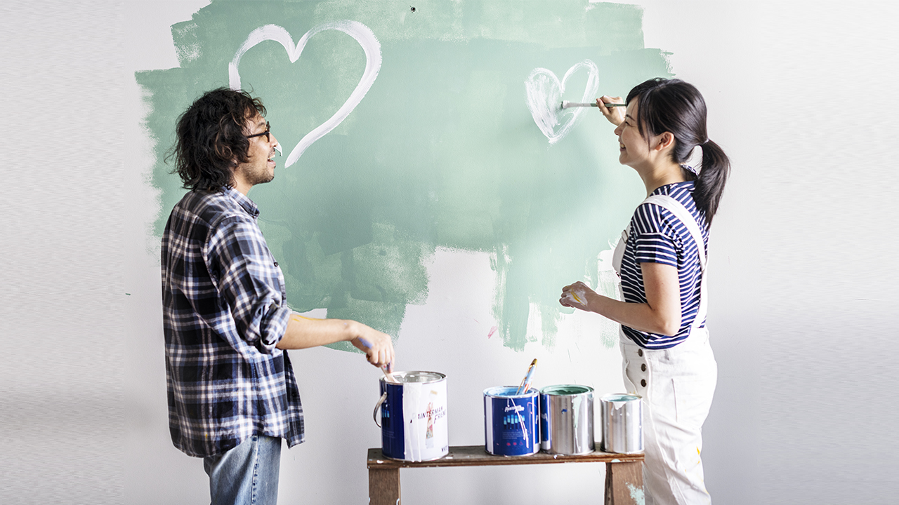 A couple is painting a wall; image used for HSBC Singapore Loan Promotions.