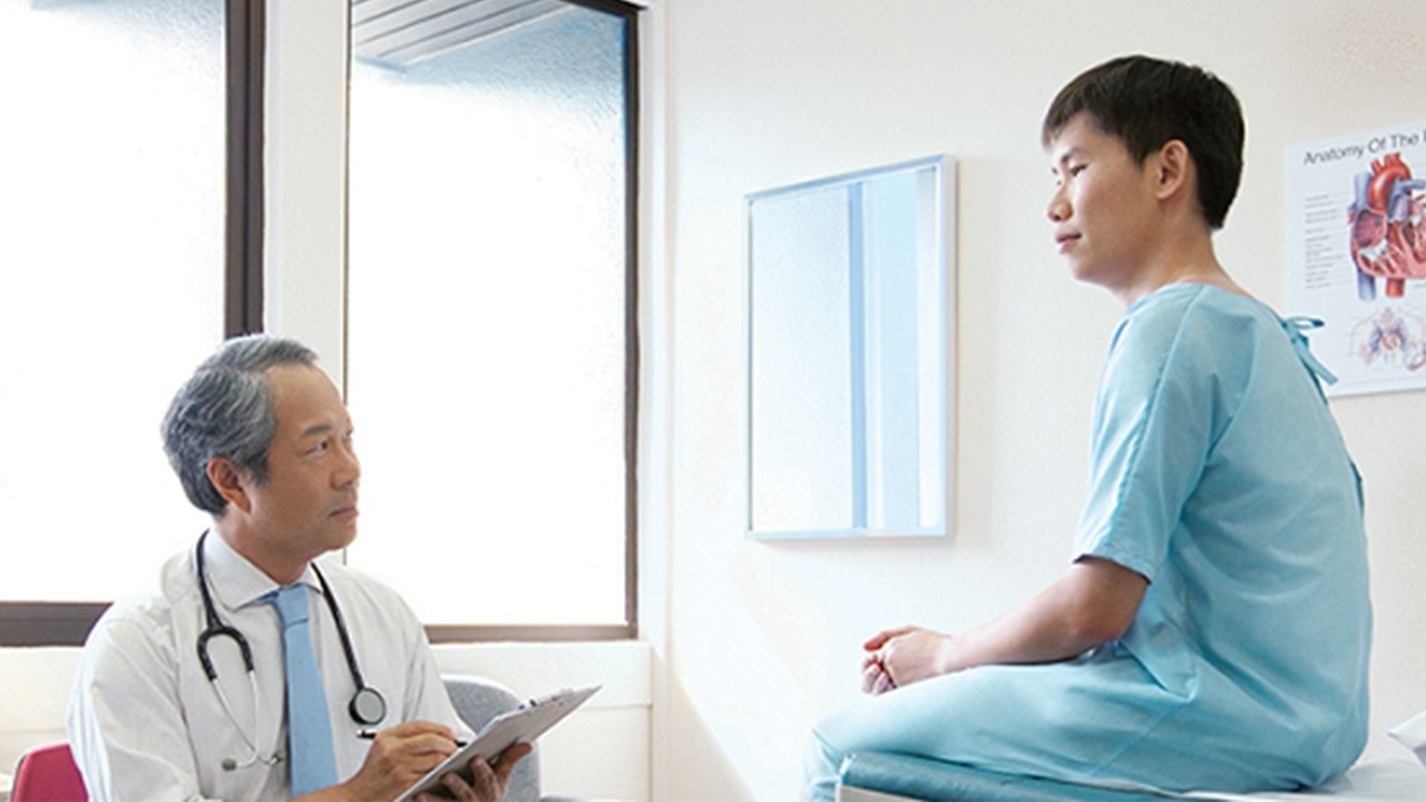 A doctor is discussing medical record with patient.