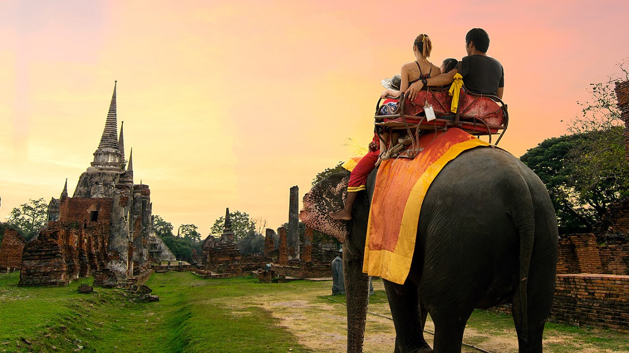 Two people are riding an elephant; image used for HSBC Singapore Everyday Global Account