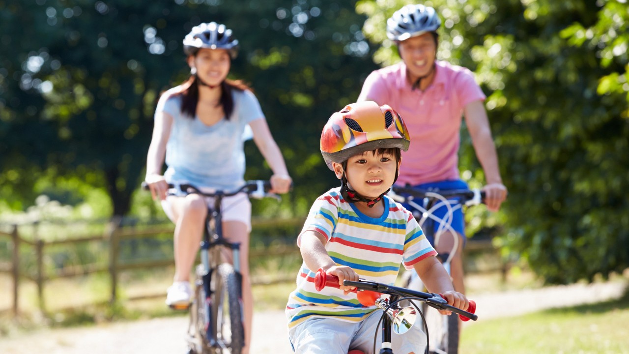 Family riding on bicycles; image use for HSBC Singapore Rewards Catalouge.