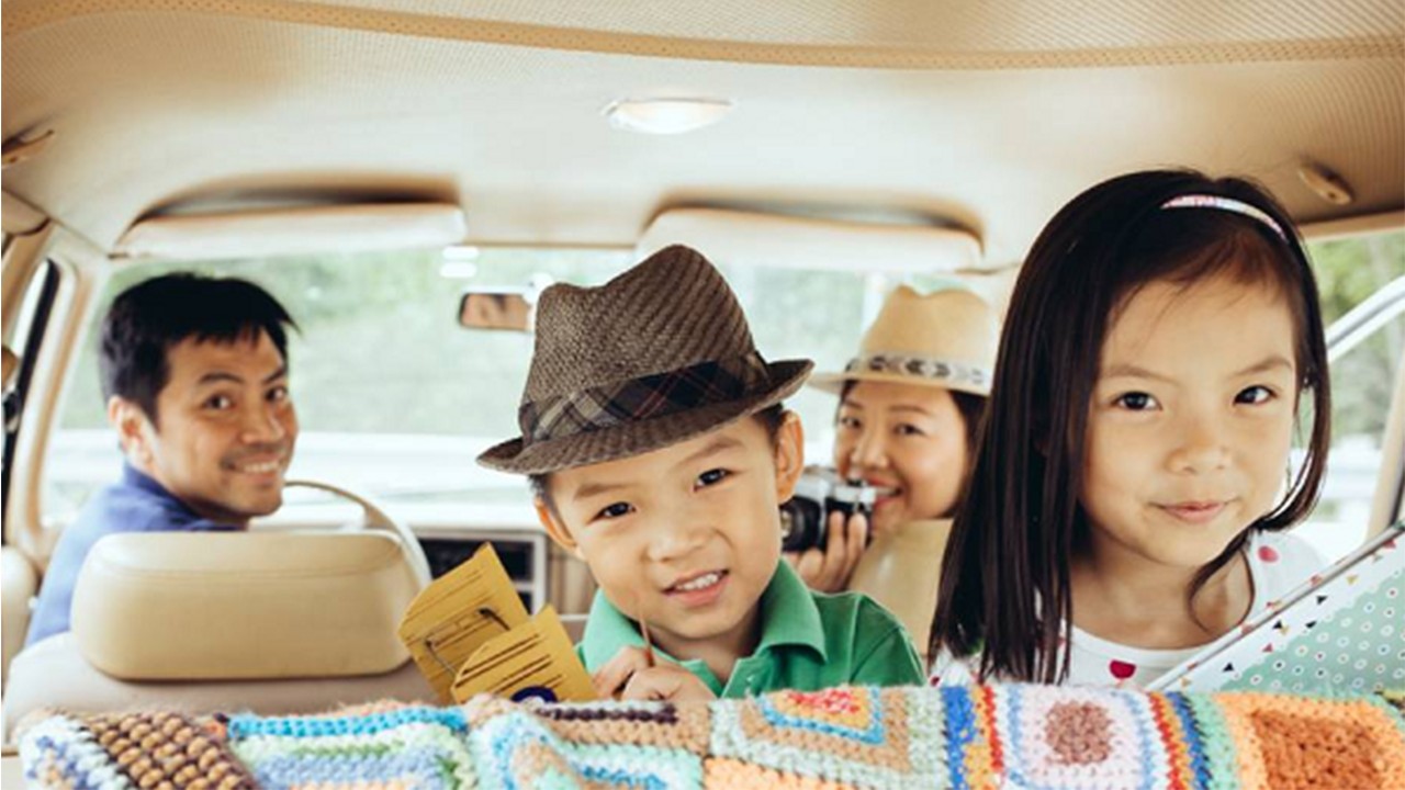 Kids are smiling in the car.