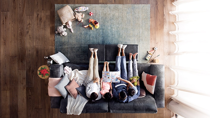 A family on a sofa; image used for HSBC Premier Mastercard Credit Card.