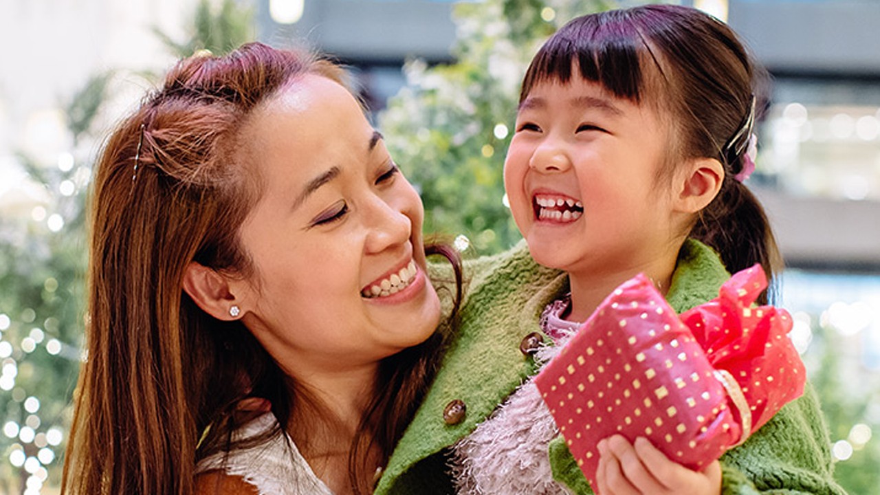 A mother sharing a gift with her daughter.