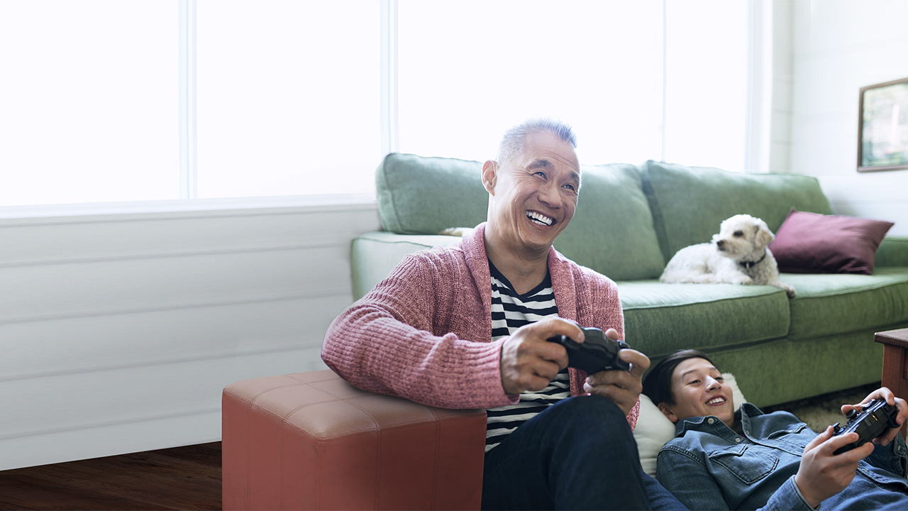 Grandfather and grandson playing video games at homeimage used for HSBC Singapore Life Retirement Income