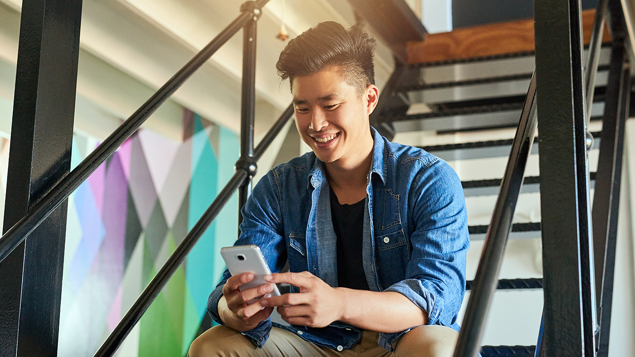 A man is using online banking; image used for HSBC Singpaore Mobile Banking.