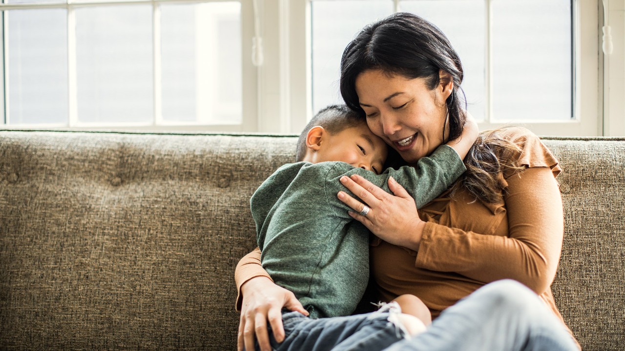 A son is hugging with his mother.