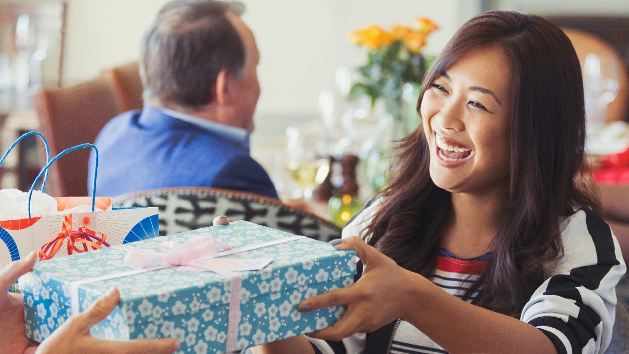 A woman is receiving a gift; image used for HSBC Singapore Rewards Programme