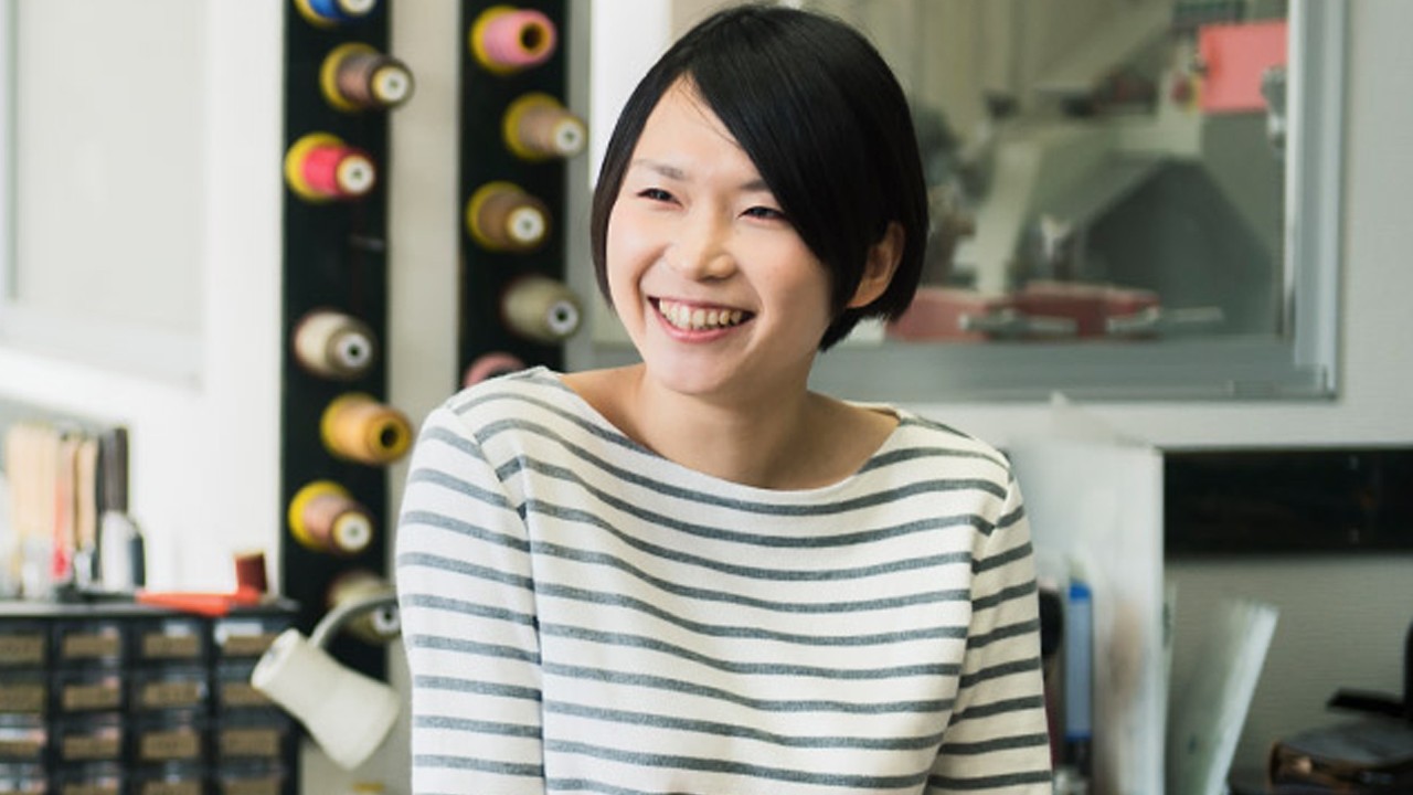 A woman smiling in gallery.