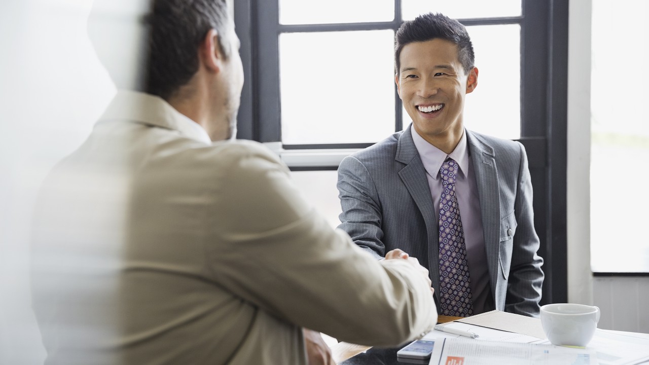 Two businessmen shaking hands; image used for HSBC Singapore Branch Finder.