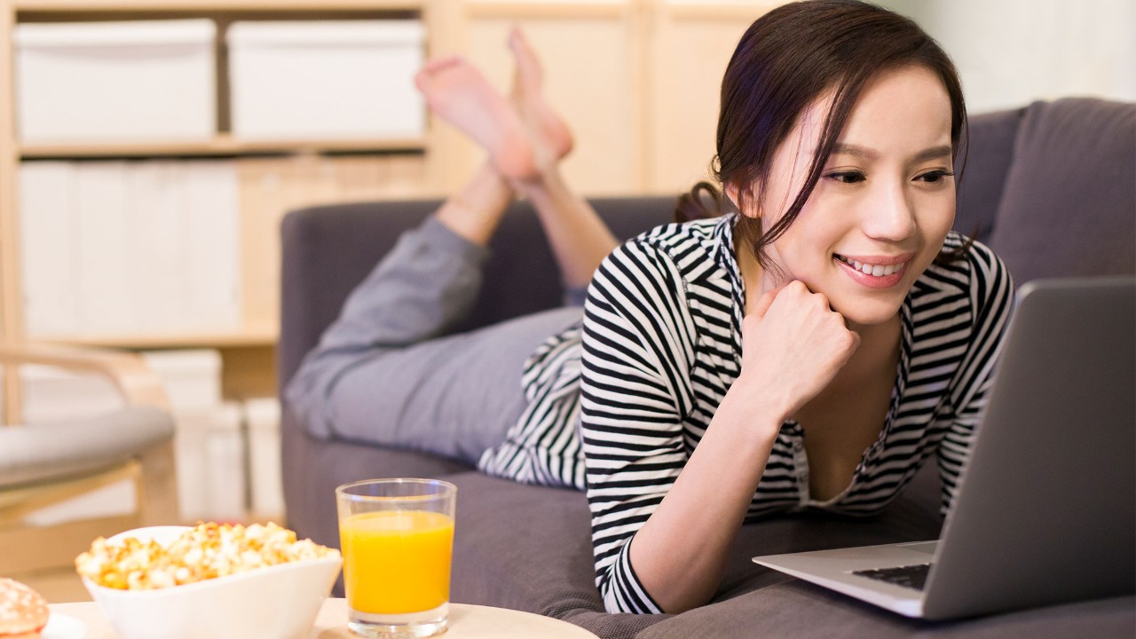 A woman is using the laptop image used for HSBC Singapore Online Banking.