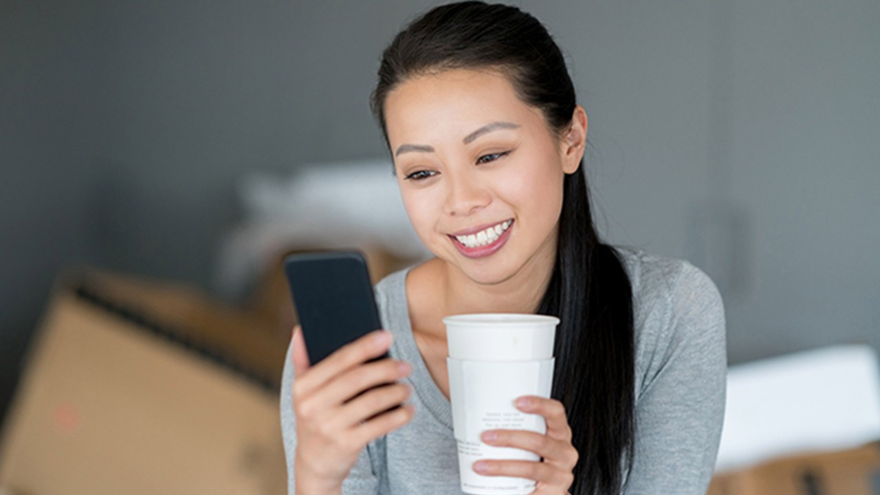 A woman is using her mobile; image used for HSBC Singapore Transfers.