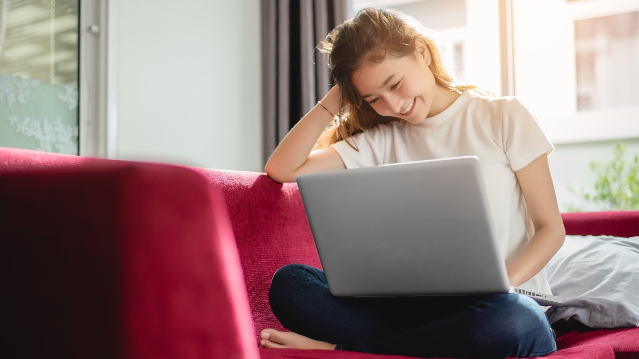 A girl is using her laptop; image used for HSBC Singapore You Don't Need a Fortune to Start investing article