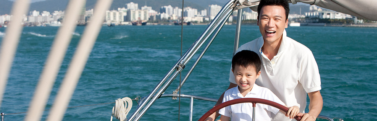 A father and son are in a boat; image used for HSBC Singapore Investments