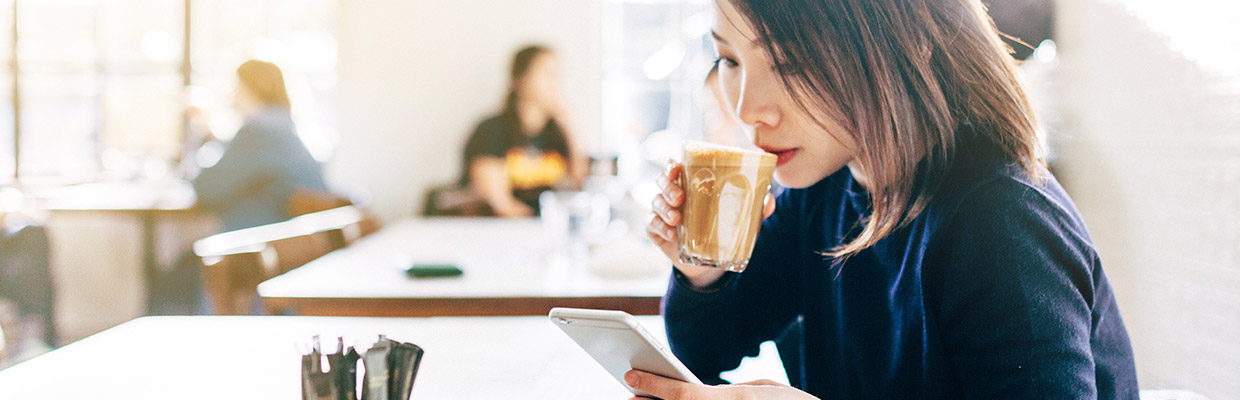 A woman is drinking coffee; image used for HSBC Singapore Insurance Help