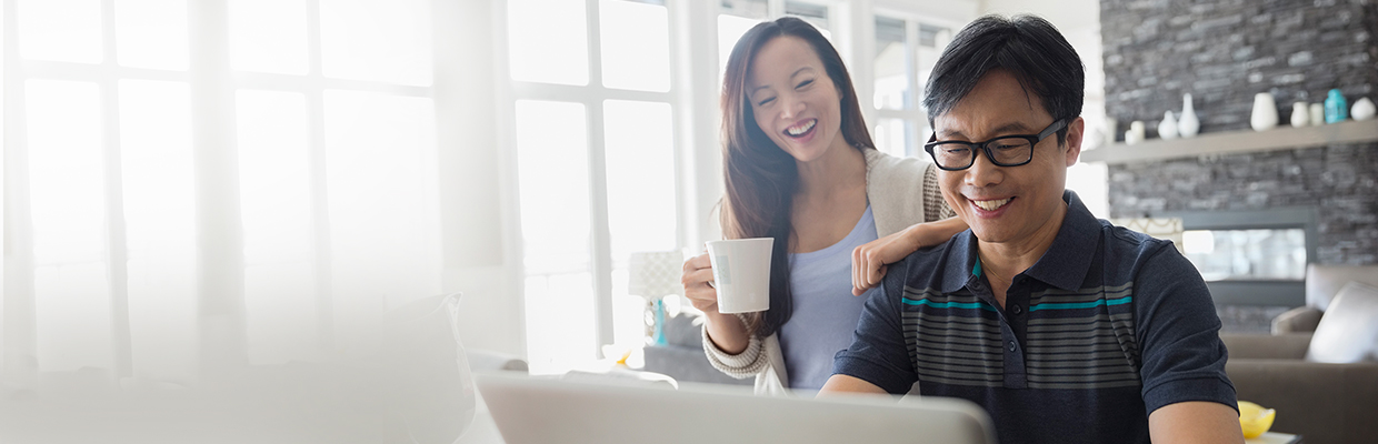 A couple is using a laptop; image used for HSBC Singapore Home Equity Loan