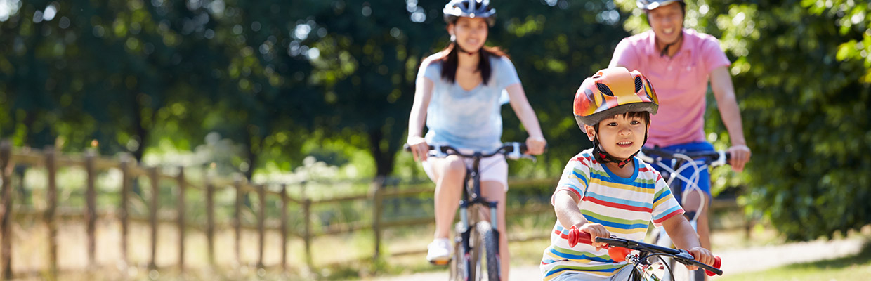 Family riding on bicycles; image used for HSBC Singapore Rewards Catalogue.