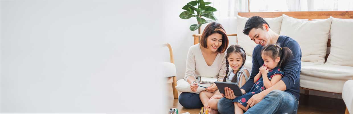 Happy family using tablet and laptop; image used for HSBC Singapore Protecting your wealth.