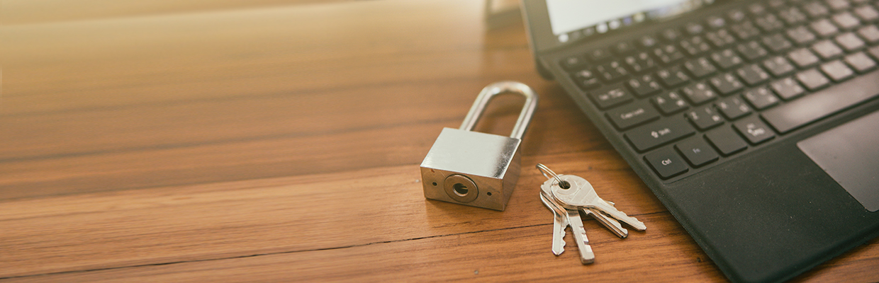 Key and lock with laptop; image used for HSBC Singapore Overview of Banking Securely article.