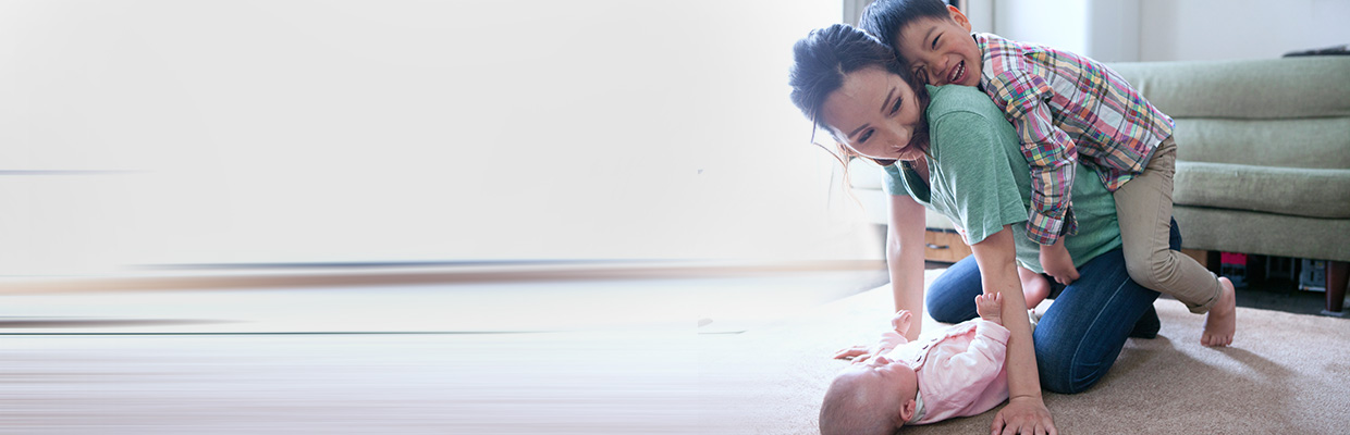 Mother and sons playing with each other; image used for HSBC Singapore Insurance.