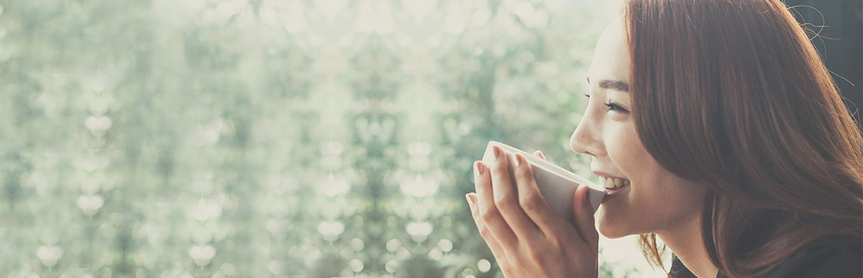 Woman drinking coffee; image use for HSBC Singapore little treats  rewards.