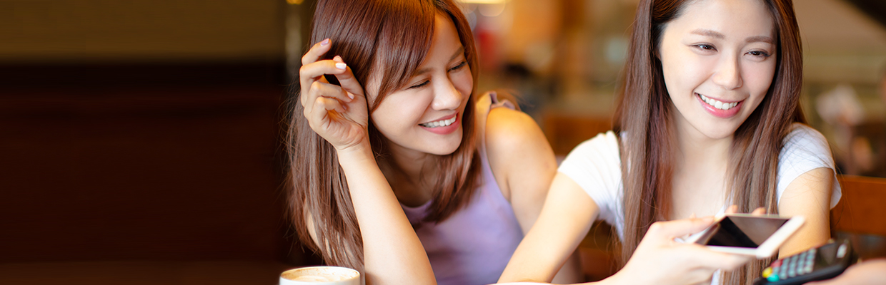 A woman is paying with her mobile phone; image used for HSBC Singapore Virtual Card