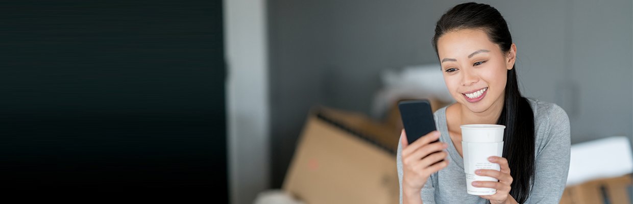 A woman is using her mobile; image used for HSBC Singapore Transfers