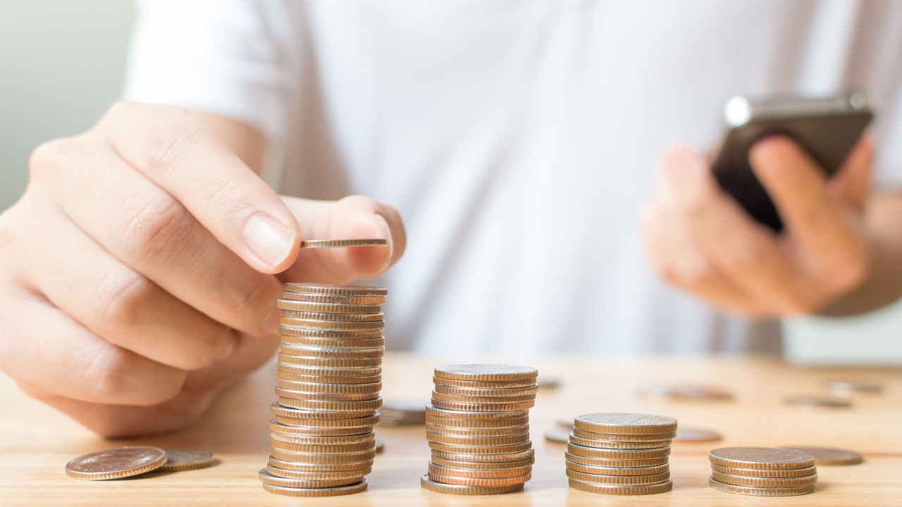 Man stacking coins.