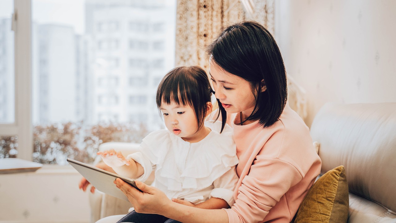 Mother and daughter using digital tablet