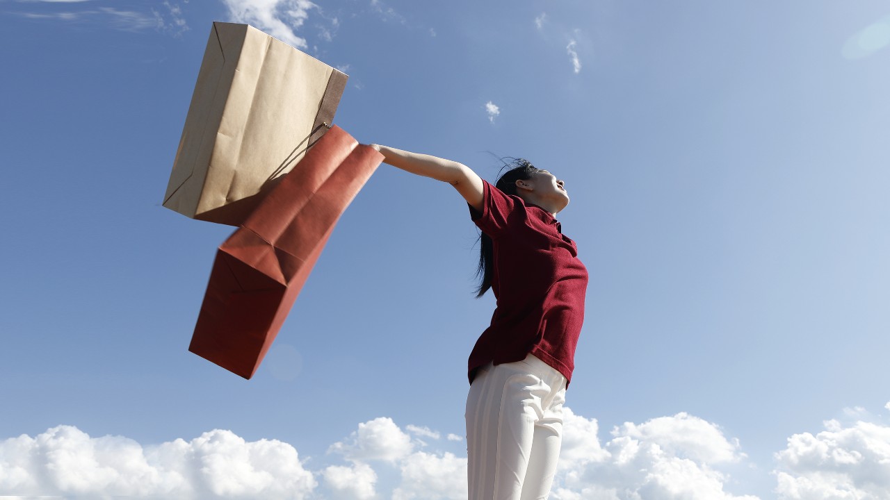 Woman holding up shopping bags