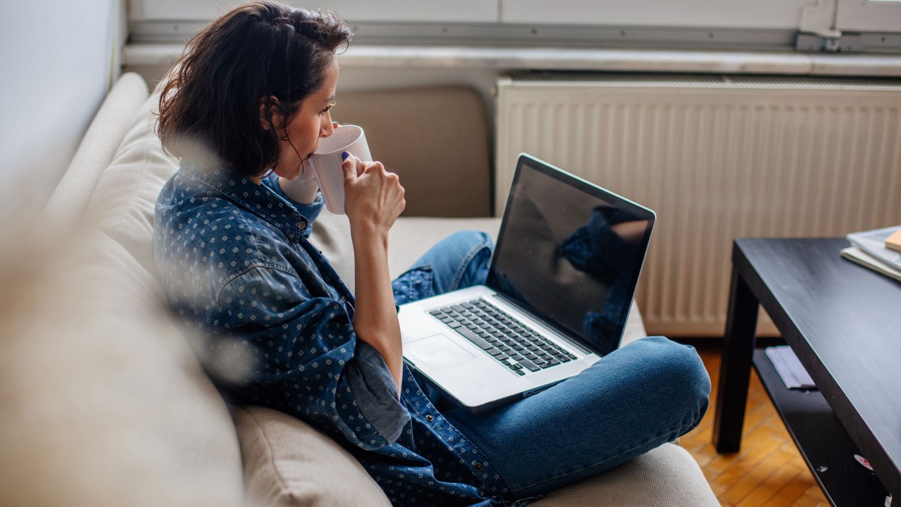Woman using laptop at home; image used for HSBC Everyday Global Account.