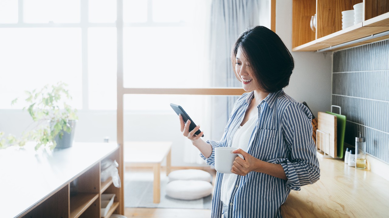 Woman using mobile phone at home