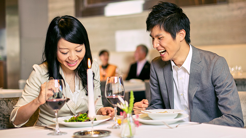 A couple are sharing a meal