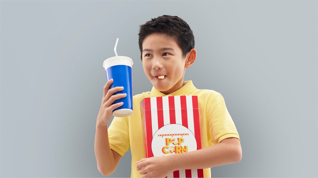 A boy eating popcorn