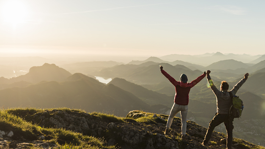 Couple reaching mountain summit; image used for HSBC 8 steps to prepare you for a great retirement article page.