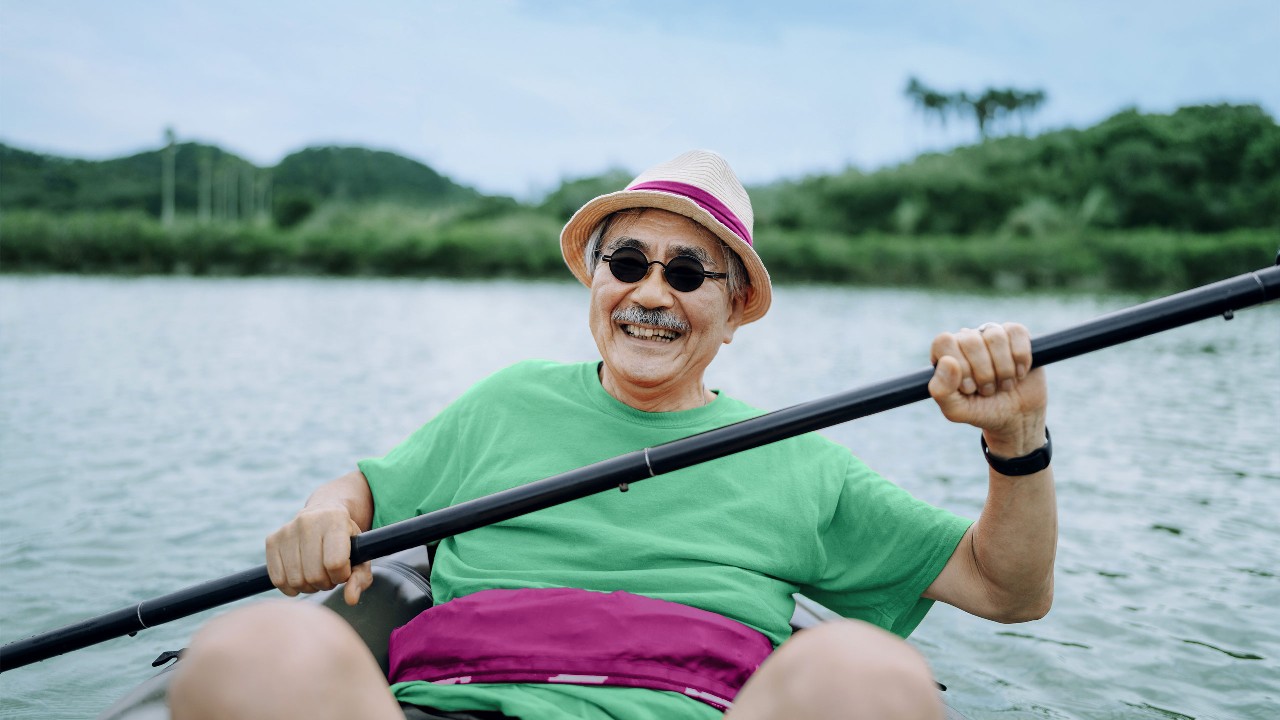 A man paddling kayak through river