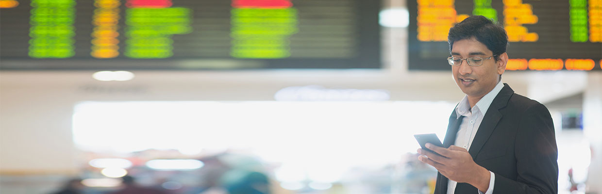 Man checking his phone ; image used for HSBC Singapore International executives.