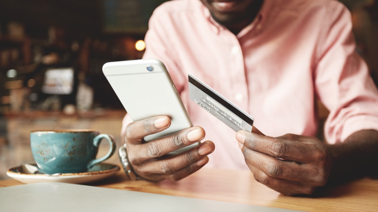 A man is paying with his mobile phone; image used for HSBC Singapore Premier