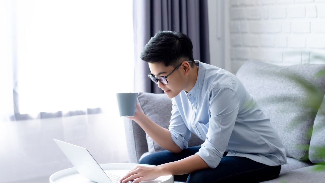 Man is reading paper in living room