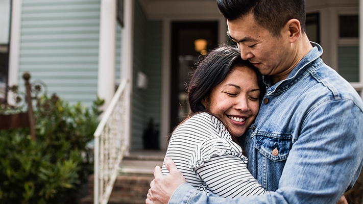 A couple hugging; image used for HSBC Singapore international mortgage.