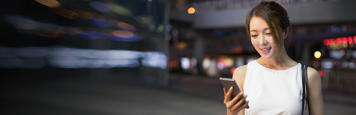 A business woman is using mobile; image used for HSBC Singapore Security token.